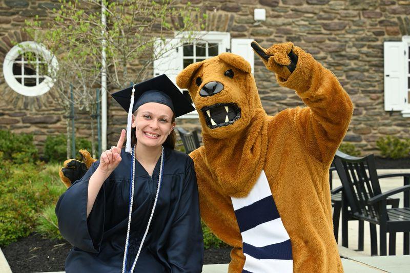 Nittany Lion mascot and female graduate outdoors